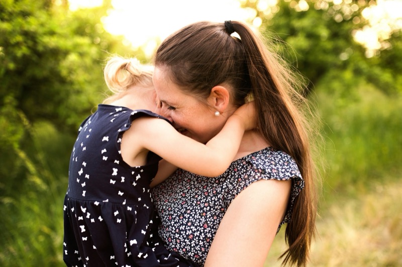 A parent hugging their child