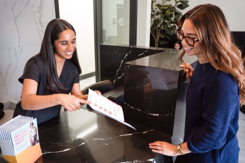 A patient checking in at the front desk